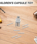 Children's capsule toy featuring silver components and transparent rods, suitable for creative play and projects.