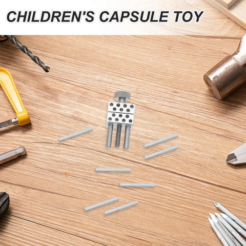 Children's capsule toy featuring silver components and transparent rods, suitable for creative play and projects.