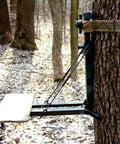 Climbing Stick Aider for Hunting and Tree Stand Safety attached to a tree in the forest, showing hand-braided rope ladder setup.