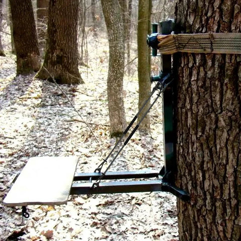 Climbing Stick Aider for Hunting and Tree Stand Safety attached to a tree in the forest, showing hand-braided rope ladder setup.