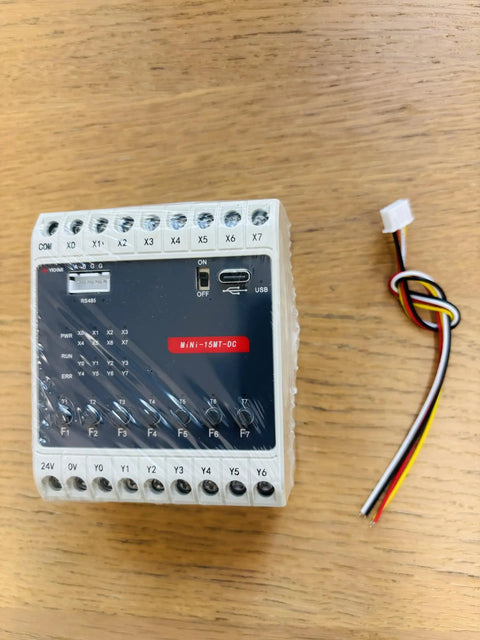 24V DC PLC Ladder Logic Controller with 8 inputs and 7 transistor outputs, FX1S RS485 HMI compatible, front view on wooden table