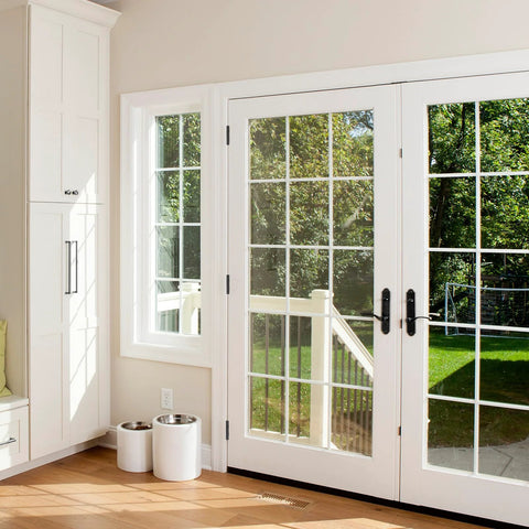 Black 4-inch ball bearing door hinges on white French patio doors; suitable for interior and exterior use.