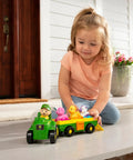Child playing with Animal Sounds Wagon Ride Musical Tractor Toy Set for Toddlers, includes push along tractor, farmer, 3 farm animals