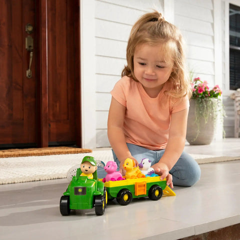 Child playing with Animal Sounds Wagon Ride Musical Tractor Toy Set for Toddlers, includes push along tractor, farmer, 3 farm animals