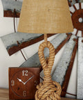 Jute Rope Table Lamp With Linen Shade Rustic Twisted Rope Accent Lamp For Living Room Cozy Warm Glow Industrial Natural Decor 13 By 13 By 28 Inches Brown on a wooden table with a clock and metal wall art.