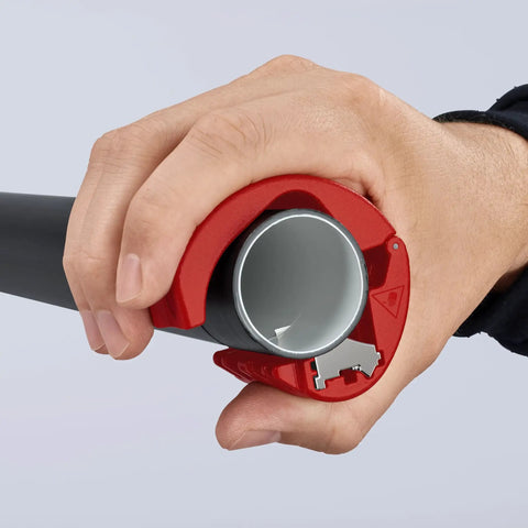 Close-up of hand using pipe cutter for plastic pipes 20 to 50 mm, ergonomic handle, cutting without shavings visible
