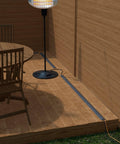 No Sweat Six Foot Floor Cable Cover And Wire Protector Channel in gray, protecting wires beside a dining table and lamp.