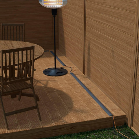 No Sweat Six Foot Floor Cable Cover And Wire Protector Channel in gray, protecting wires beside a dining table and lamp.