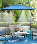 Outdoor patio with blue umbrella and misting system 26 foot kit with brass nozzles and three quarter inch brass adapter cooling area