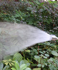 18 Inch Soft Rain Watering Wand with Shut Off Valve spraying water on garden plants