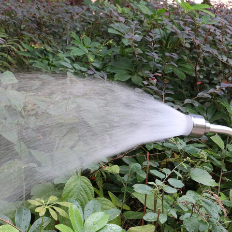 18 Inch Soft Rain Watering Wand with Shut Off Valve spraying water on garden plants