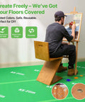Artist painting on protected floor with Heavy Duty Floor Protector For Construction And DIY, 39x100 Inch Waterproof Carpet Shield.