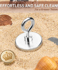 Neodymium Fishing Magnet With 150 Lbs Pulling Power And Lifting Eye Bolt For Retrieval In Lakes And Beaches on sand with coins