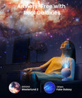 Woman relaxing under Galaxy Star Projector For Bedroom With Replaceable Optical Film Discs, Home Planetarium Night Light