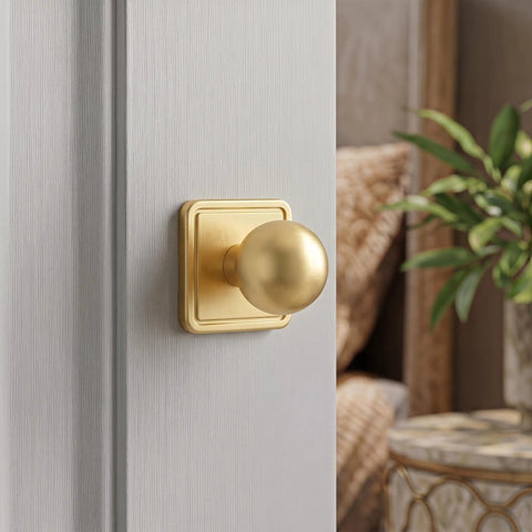 Slick Gold Zinc Alloy Cabinet Knobs With Premium Square Backplate And 1 Inch Round Ball Pulls For Kitchen Drawers Dressers Wardrobes Top Shelf Cupboard Furniture Hardware mounted on a grey cupboard.