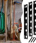 Four black 6-hole landscape trailer racks with rubber grommets and mounting hardware for lawn tools, shown in garage setting.
