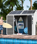 8x6 Ft Resin Storage Shed With Floor, Waterproof Outdoor Tool Shed, Lockable Door And Two Windows by poolside with surfboards.
