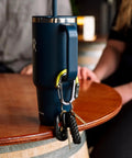 HeroClip Small Carabiner Clip And Hook Three In One For Purses Strollers And Backpacks Stealth Black holding keys on mug
