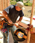 Person using a sturdy tape measure holder and drill holster with belt clip hands free tool pouch for measuring tapes on site