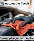 Mechanic using a Red Cotton Shop Towel for Garage and Auto Care, wiping engine in a car, showcasing absorbency and durability for oil spills.