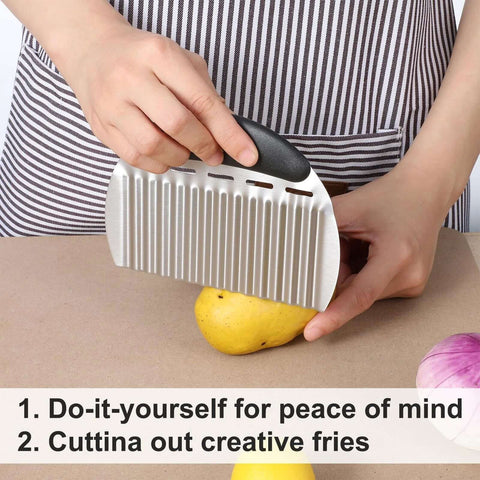 Large stainless steel crinkle cutter with black handle slicing a potato