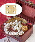 Open jewelry box with pearl necklaces and an Eight Piece One Inch Brass Hinges Set With Thirty Eight Gold Screws for small cabinets.