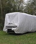 Heavy Duty Poly Tarp 10x15 Feet White covering a vehicle, outdoors, demonstrating weather resistance and multi-purpose use.