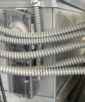 Close-up of Three Quarters Inch Galvanized Steel Flexible Electrical Conduit 25 Ft Roll Smooth Interior installed on panel box