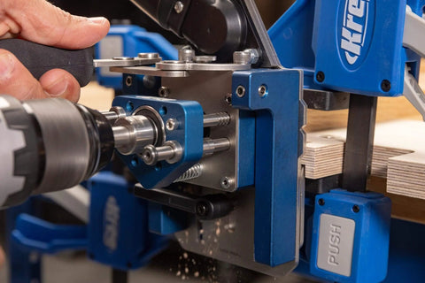 Close-up of MortiseMate Loose Tenon Jig in use with drill, showing auto indexing and mini work surface for woodworking joinery.