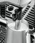 Heavy Duty Fully Automatic Espresso Machine With Slick Touchscreen Interface And Pro Grade Dual Boiler Rig For Killer Specialty Coffee At Home Featuring Precise Thermal Regulation And Smooth Simultaneous Brewing milk frothing wand close-up in stainless steel jug