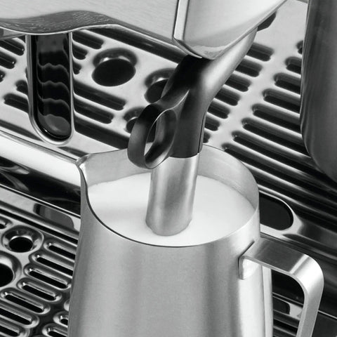 Heavy Duty Fully Automatic Espresso Machine With Slick Touchscreen Interface And Pro Grade Dual Boiler Rig For Killer Specialty Coffee At Home Featuring Precise Thermal Regulation And Smooth Simultaneous Brewing milk frothing wand close-up in stainless steel jug