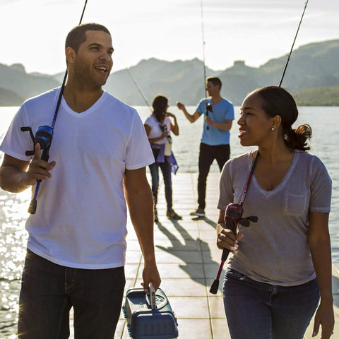Two people fishing on a dock with Custom Spincast Reel And Rod Combo With 6 Foot Two Piece Fiberglass Rod EVA Handle