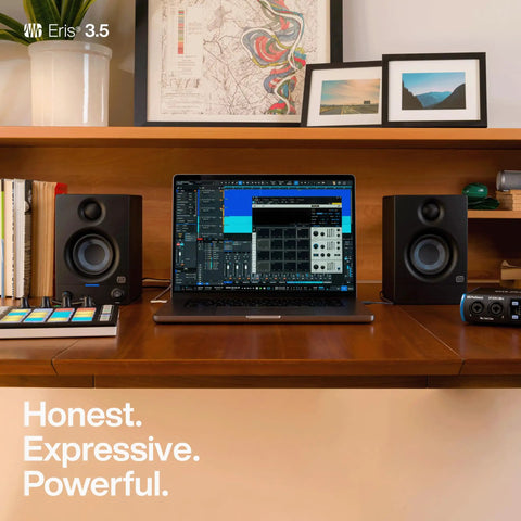 Desktop setup with Eris 3.5 Studio Monitors Pair for Near Field Mixing and HiFi Desktop Listening next to a laptop setup.