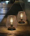 Set Of 2 Metal Cage LED Lanterns Battery Powered Cordless Accent Lights For Indoors Outdoors, warm glow on stone ledge