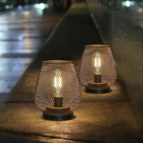 Set Of 2 Metal Cage LED Lanterns Battery Powered Cordless Accent Lights For Indoors Outdoors, warm glow on stone ledge