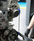 Pro Grade Multi V Belt Pulley Alignment Tool Featuring An Adjustable Steel Rod And Heavy Duty Magnets To Knock Out Misalignment And Get Your Engine Belts Tracking True with heavy duty magnets in use on an engine.