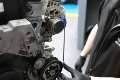Pro Grade Multi V Belt Pulley Alignment Tool Featuring An Adjustable Steel Rod And Heavy Duty Magnets To Knock Out Misalignment And Get Your Engine Belts Tracking True with heavy duty magnets in use on an engine.
