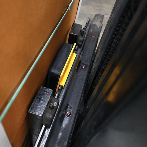 FCB-818 Class II Fork Truck Carriage Bumper with molded rubber and steel, heavy duty, mounted on forklift carriage in warehouse.