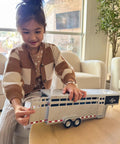 Child playing with Sundowner Horse Trailer With Gooseneck Hitch For Farm Toys And Toy Trucks Realistic Details 1:20 Scale