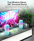 Powerful Portable Wireless Bluetooth Speaker With Stereo Sound LED Lights And Long 36 Hour Battery Life IPX4 Waterproof BT53 TWS Pairing Built In Mic Ideal For Outdoors Home Parties And Travel Powder Blue Gift on a table with glowing RGB lights.