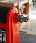 Close-up of red wood lathe headstock with silver 1x8TPI female to 1-1/4x8TPI male threaded adapter mounted on the spindle.