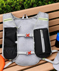 All Day Hydration Vest With Water Reservoir For Trail Ready Rides On The Go And Runs on a bench with bottle and cap