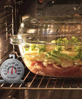 Stainless Steel Oven Thermometer 150 to 600 F Leave-In Safe for Oven and Grill next to a casserole dish in oven