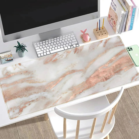 Rose Gold Marble Desk Pad For Mega Size 31.5 By 15.75 Inch Setup With Ultra Smooth Lycra Surface on a white desk