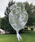 See Through Garden Netting 8.2 By 16.4 Feet Bug And Bird Barrier Netting For Plants Flowers Vegetables Fruit Trees UV Resistant Reusable Planter Mesh For Outdoor Gardens All Year Protection covering a tree for protection.