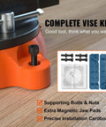 Front view of orange VEVOR 6-inch bench vise mounted on a workbench with bolts and jaw pads.