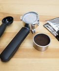Top Tier Stainless Steel Espresso Machine With Reliable 19 Bar Italian Pump And Quick Ground Or ESE Pod Brewing tools on a wood surface.
