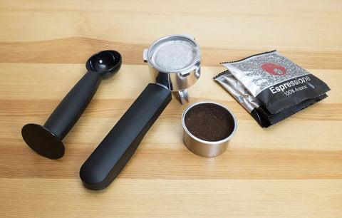 Top Tier Stainless Steel Espresso Machine With Reliable 19 Bar Italian Pump And Quick Ground Or ESE Pod Brewing tools on a wood surface.