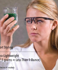 Person wearing Crazy Light Safety Glasses With Floating Lens Metallic Black Frame And Gray Lens Uvextreme Anti Fog Coating.
