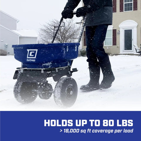 Person using Boss Pro Grade Salt Spreader For Ice Melt With 80 Lb Capacity, Walk Behind Contractor Model on snowy driveway